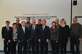 The group standing in front of a banner that reads "Sino-Swiss Organic Agriculture Research Center (SSDARC), Establishment 23 March 2017, Frick, Switzerland".