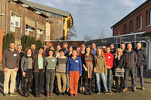 A group of people in front of a building