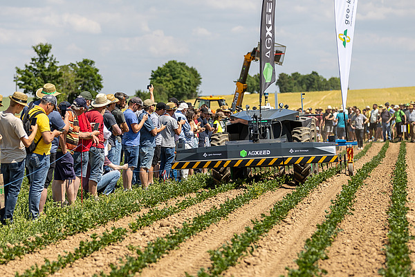 Teilnehmende an einer landwirtschaftlichen Maschinenvorführung.