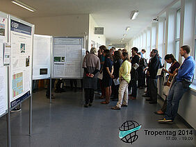 A group of people watching some posters