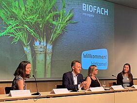Four people at a podium