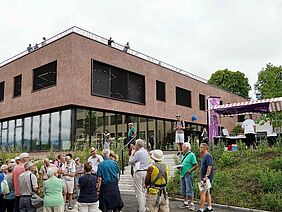 Group of people with the Alvarium in the background.