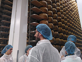 Lagerung von Käse. Menschen, die sie anschauen.