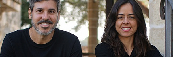 Ein Mann und eine Frau sitzen draussen auf einer Treppe.