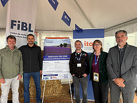 Fünf Menschen an einem Stand.