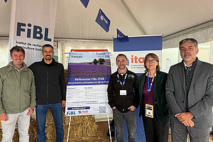 Five people at a stand.