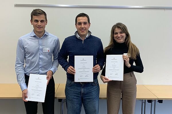 Drei junge Wissenschaftler*innen mit dem Preis-Zertifikat in den Händen