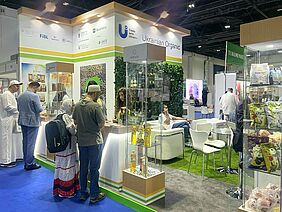 People standing at an expo stand.