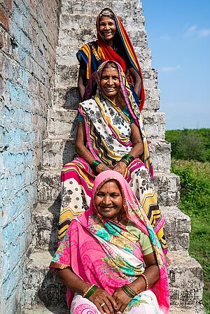 Ajodhya Bai and two women sitting on stairs