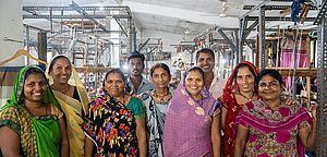 A group of people in a weaving mill