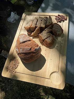 Ein teilweise angeschnittenes Brot auf einem Holzbrett.