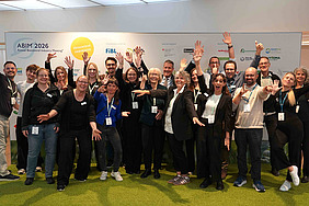 The photo shows the ABIM team in front of a promotional backdrop. A total of around 25 FiBL staff members took part.