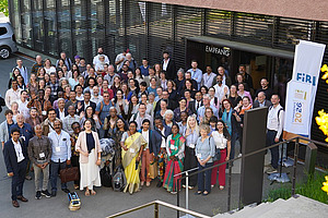 A large group of people in front of a building.
