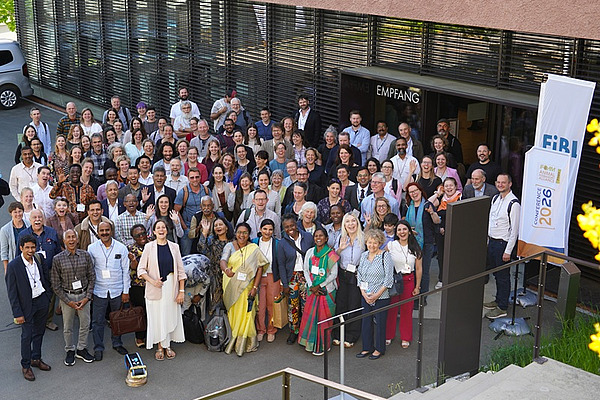 A large group of people in front of a building.