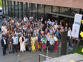 A large group of people in front of a building.