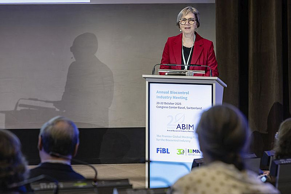 A woman standing at a podium.