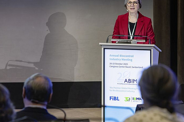 A woman standing at a podium.