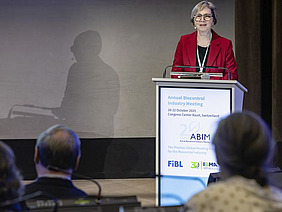 A woman standing at a podium.