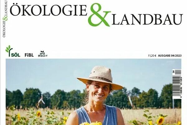 Magazincover der aktuellen Ausgabe: Eine Frau mit Sonnenhut steht auf einem Feld und lacht in die Kamera