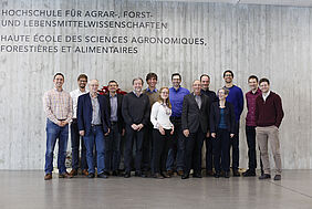 Members of FiBL, HAFL and SFS are standing in front of a wall at the School of Agricultural, Forest and Food Sciences.