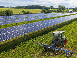 Agri-PV system in a field with a tractor.