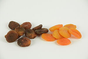 Organic brown dried apricots and conventional orange dried apricots. 