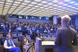 A room full of people from the perspective of a speaker