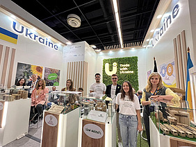 A group of people at a Ukrainian stand.