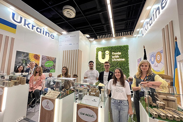 A group of people at a Ukrainian stand.