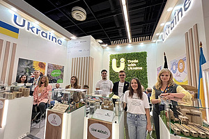 A group of people at a Ukrainian stand.