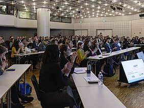 A room with people sitting at tables.
