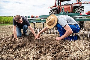 Hansueli Dierauer and farmer Daniel Böhler measure reduced tillage.